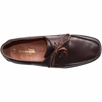 Interior view of men's moccasin shoes featuring a round-toe cap and lace fastener. The design includes a decorative leather strap for added style and a comfortable fit. These genuine cowhide leather shoes have a block heel and a classic shoelace closure.