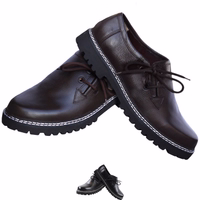 A pair of Bavarian traditional shoes featuring a round-toe cap and block heel. These handmade shoes offer a secure and comfortable fit, crafted from 100% lamb nappa leather. They have a short shaft and are designed with side lacing for a classic touch.