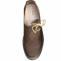Inner view of dark brown Bavarian traditional shoes made from 100% smooth leather. Features include a block heel, round toe cap, elegant design, and rubber sole, with 'German Wear' marked inside for authenticity.