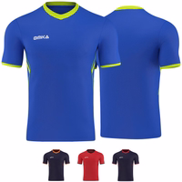 Front and rear views of the Omka sport shirt, featuring a blue base with green accents. This jersey, designed for sports enthusiasts, is suitable for soccer, volleyball, and handball. It is styled as a World Cup jersey, perfect for fans and sports events.