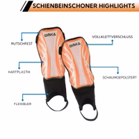 Nahaufnahme der orangefarbenen Schienbeinschoner mit hervorgehobener schützender EVA-Schaumstoffeinlage, atmungsaktiver Außenhülle und verstellbarem Klettverschluss.