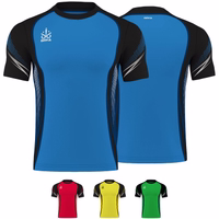 Omka Teamwear Football jersey 100% Polyester Front and back views of a blue Omka sport jersey featuring black accents. The jersey has short sleeves, a round neck, and is made from 100% polyester for high durability. It includes a drawstring closure at the front and showcases a dotted pattern.