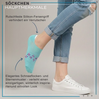 Ankle sock with visible snowflake and star pattern, lying flat
