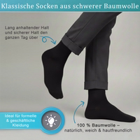 Black business formal sock lying flat, front side visible, German text on packaging visible