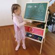 Kleines Mädchen malt an einer Standtafel